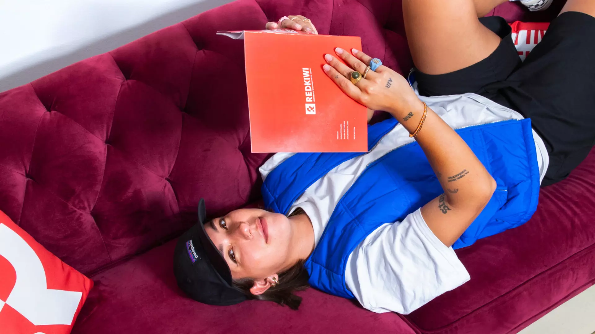 Girls lays on couch reading a book