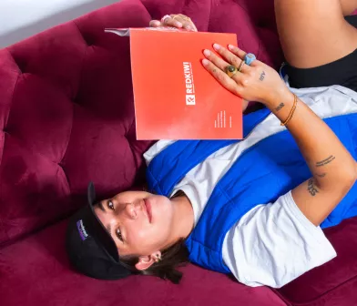 Girls lays on couch reading a book