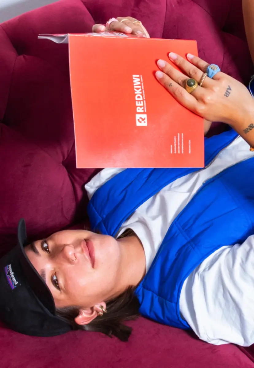 Girls lays on couch reading a book