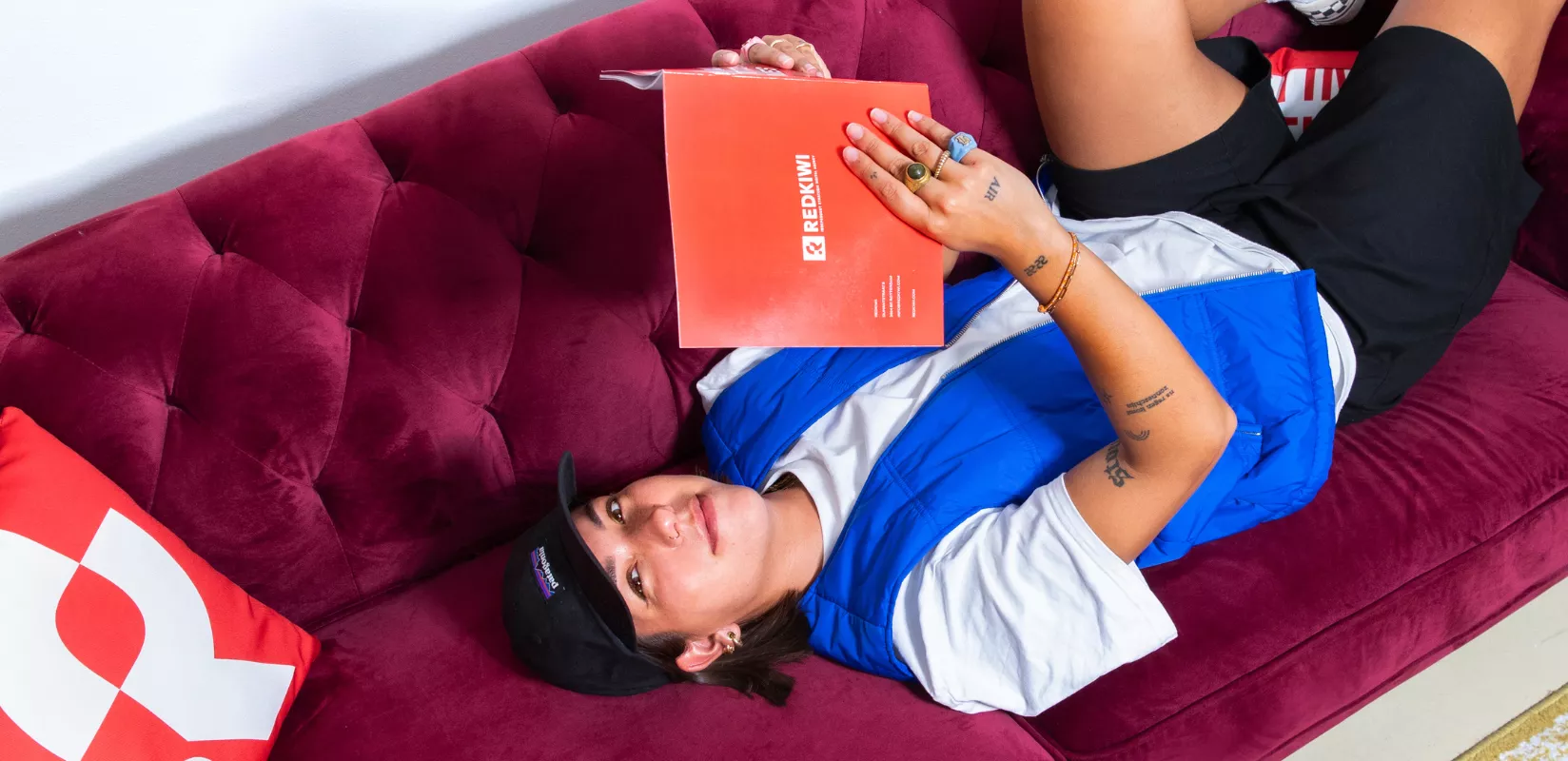 Girls lays on couch reading a book